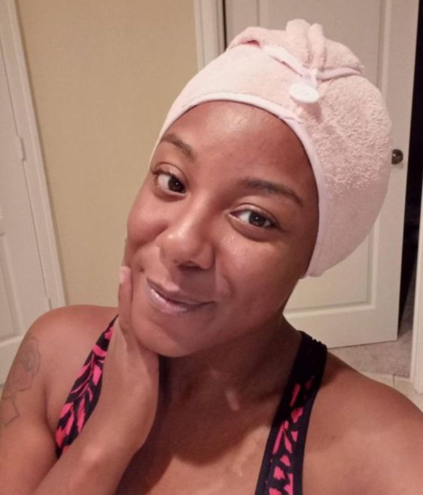 A woman using the microfiber hair towel.