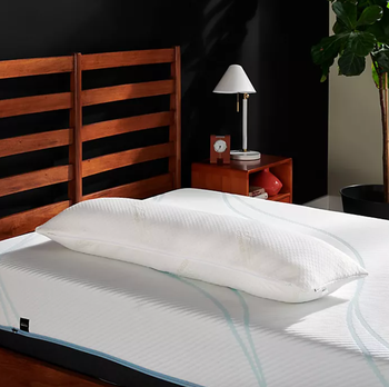 An image of the white pillow placed on a white mattress.