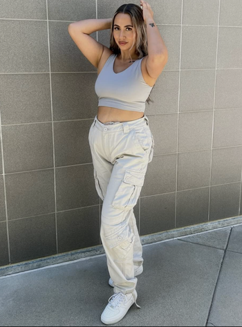 Reviewer wearing high-waisted khaki cargo pants.