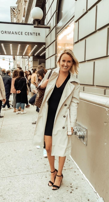 A reviewer shows off the beige trench coat.