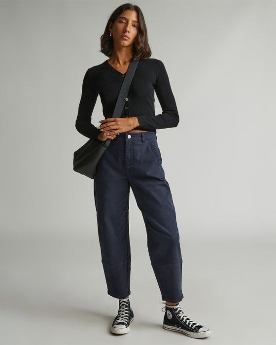 A model is wearing the pants in navy.