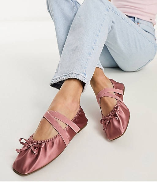 A model is wearing the shoes in pink.
