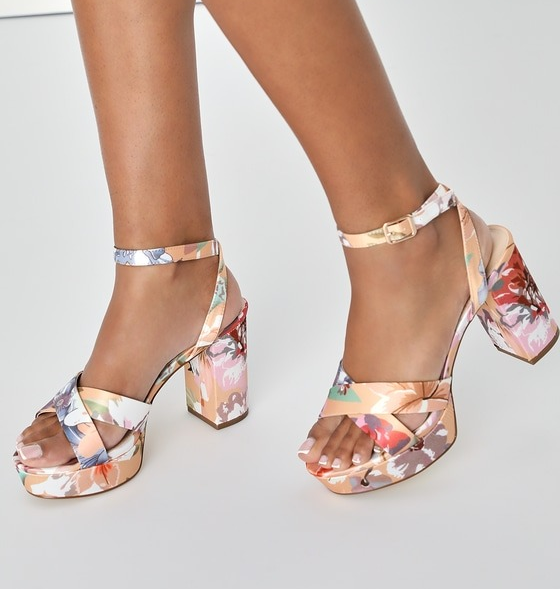 A model wearing the shoes with a pastel floral pattern.