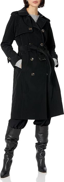 The model is showcasing the black trench coat.