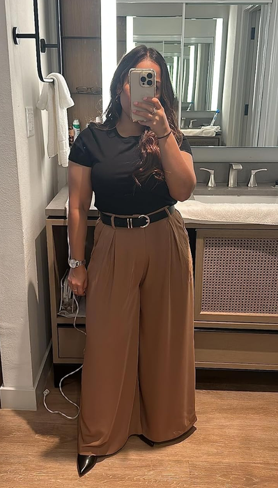 A reviewer demonstrates the pants in brown.