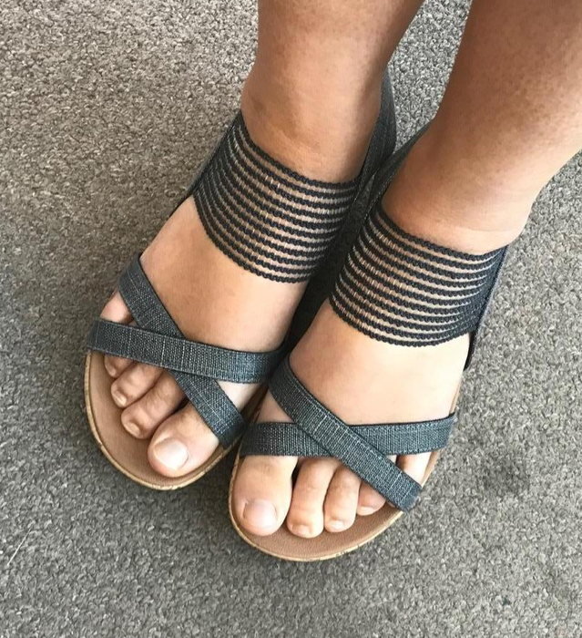 A reviewer is pictured wearing black sandals.
