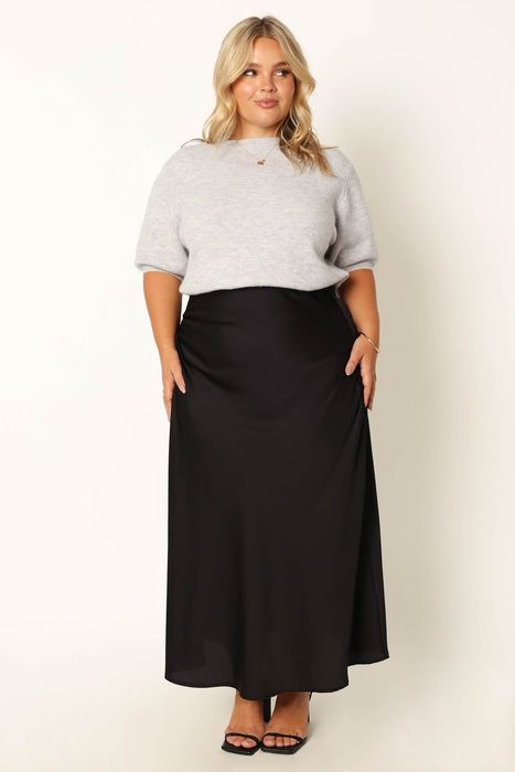 A front view of a different model wearing the gray sweater.