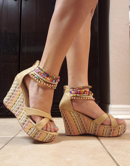 A reviewer is seen wearing the wedge sandals.