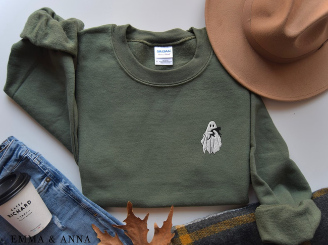 Green crewneck sweater featuring an embroidered ghost holding a cat.