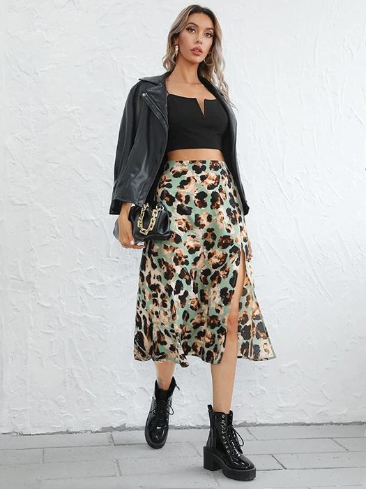 a model showcasing the skirt in a vibrant green multicolor print