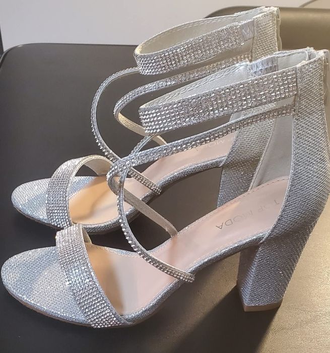 A reviewer shows off the silver heels in their image.