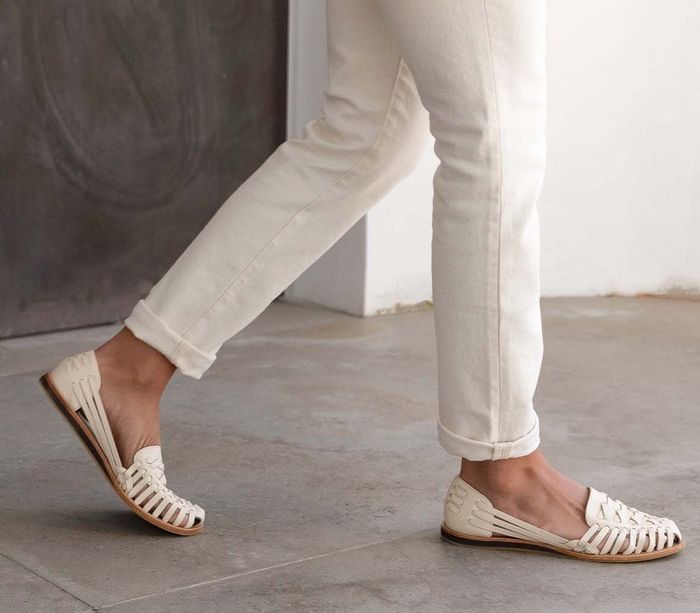 A model is wearing the shoes in white.