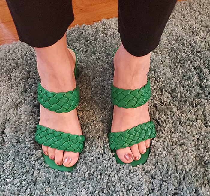 A reviewer is seen wearing shoes in a vibrant green color.