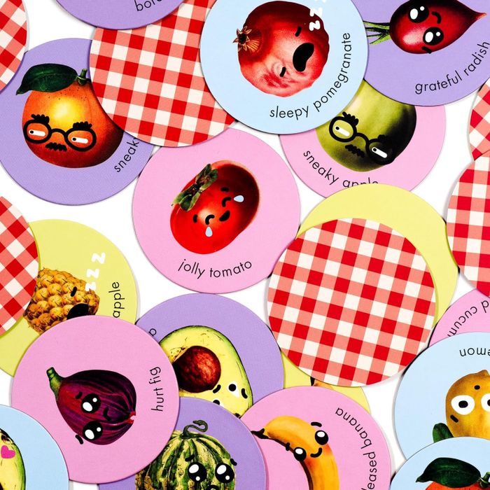 A set of circular stickers showcasing various fruits and vegetables, each displaying a whimsical facial expression, including 'sleepy pomegranate,' 'jolly tomato,' and 'hurt fig.'