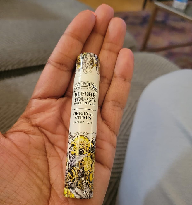 A reviewer holding the tube in their hand, showing that it’s about the size of a tube of lip gloss.