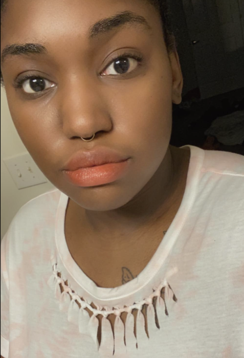 A reviewer showcasing a pink shade.