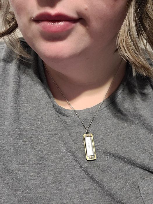 A reviewer wearing the harmonica as a necklace.