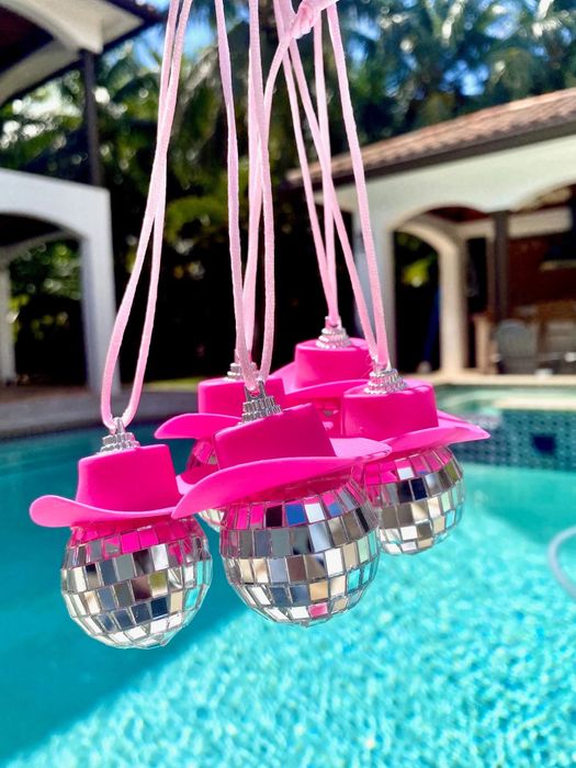 A mini disco ball topped with a pink cowgirl hat