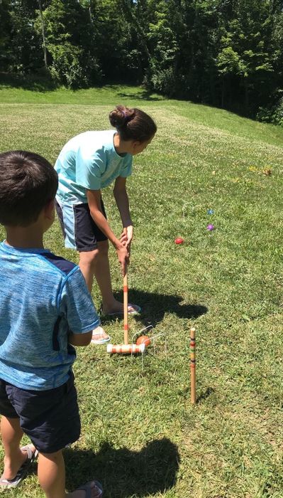 A picture from the reviewer showing their family enjoying a game of croquet together.