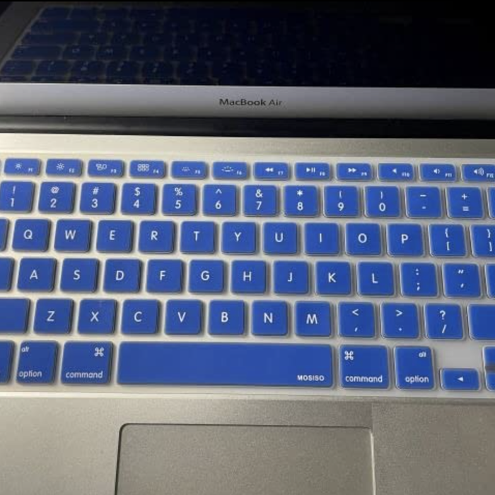 A blue keyboard cover completely shielding a laptop keyboard.