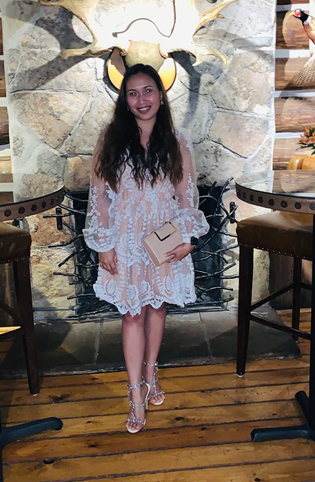 A reviewer holding the clutch while standing in a restaurant