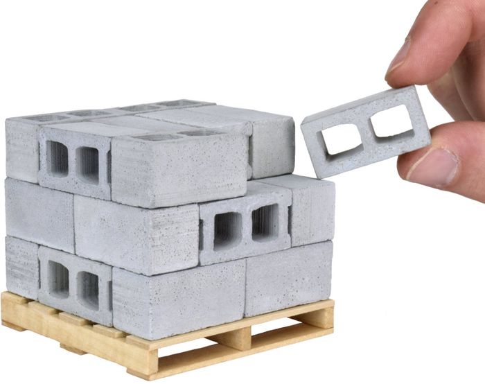 Miniature cinderblocks stacked on a pallet.