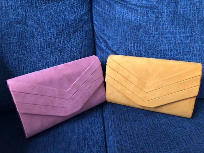 A product shot featuring the clutch in a vibrant mix of purple and yellow