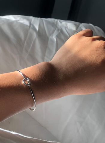 A reviewer sporting the silver version of the bracelet.