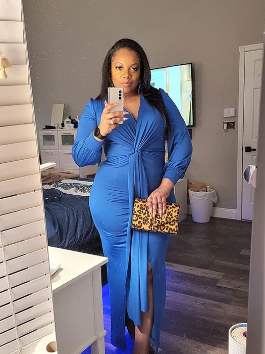 A mirror selfie from the reviewer, showcasing the leopard print clutch.