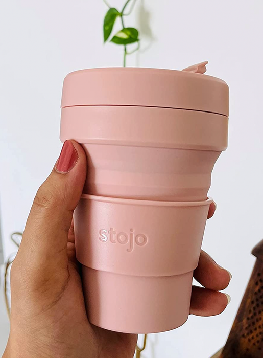 A small pink coffee cup with a lid