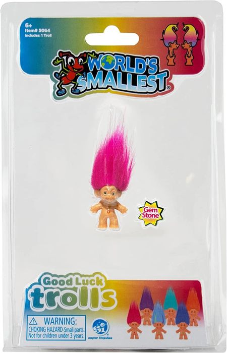 The packaging for a troll doll, featuring bright pink hair.