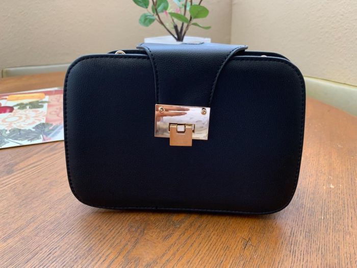 Image from the reviewer showcasing the black clutch bag