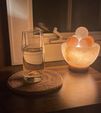 The cup resting atop the lid of the carafe.