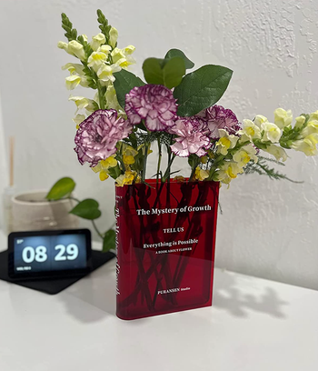 A striking red variant of the vase with bright, colorful flowers elegantly positioned on a desk.