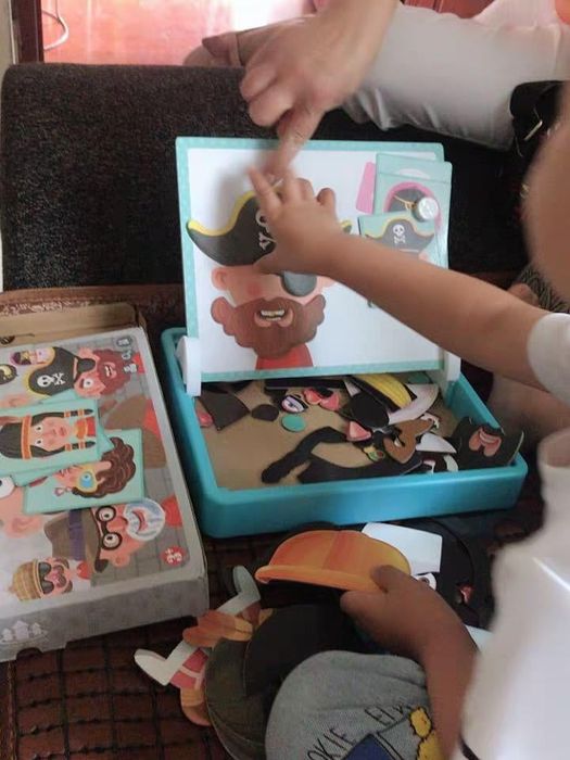 A child having fun creating a pirate face using the magnetic pieces