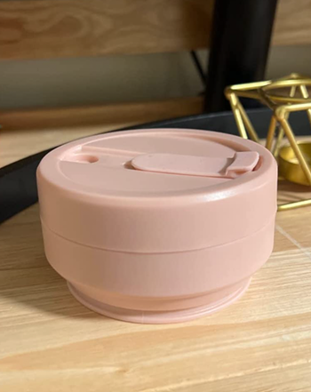 The coffee cup, folded down to the size of a hockey puck