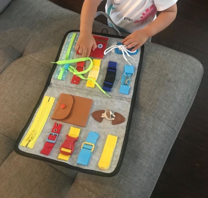 A child interacting with the busy board.