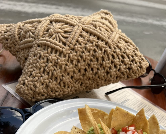 The same reviewer showing a photo of the clutch resting in front of a plate of delicious food.