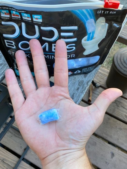 Reviewer holding a package of Dude Bombs Stank Eliminator.
