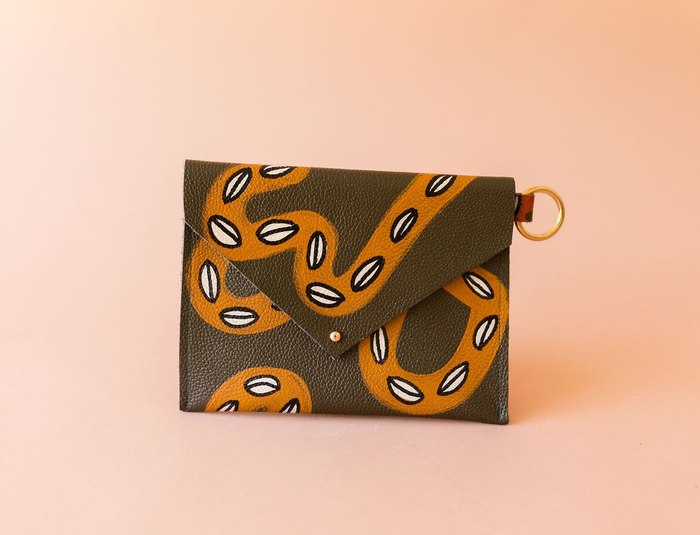 A product image displaying a leather clutch.