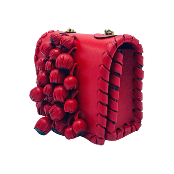A product shot of the purse in a bold red hue