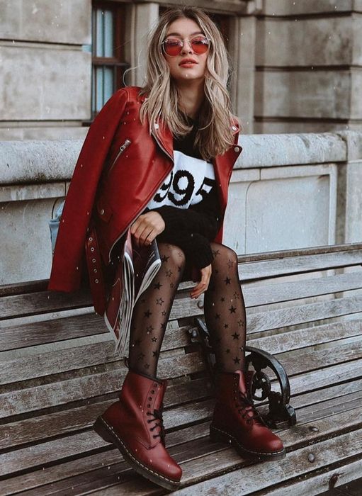 A model showcasing the boots in a stylish dark red color.