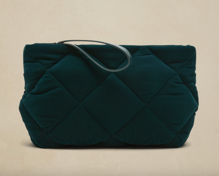 A green velvet quilted clutch.