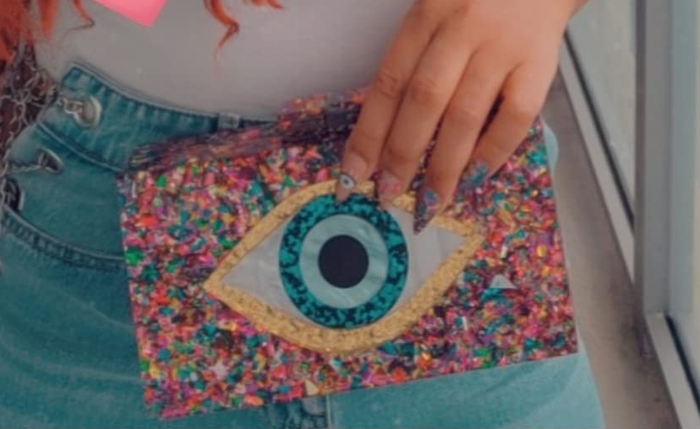 A reviewer showcasing a clutch purse
