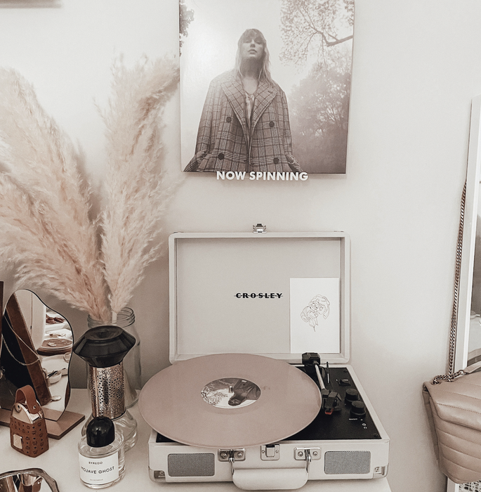 A now spinning shelf featuring *Folklore* by Taylor Swift.