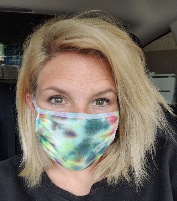 A reviewer models a tie-dye mask