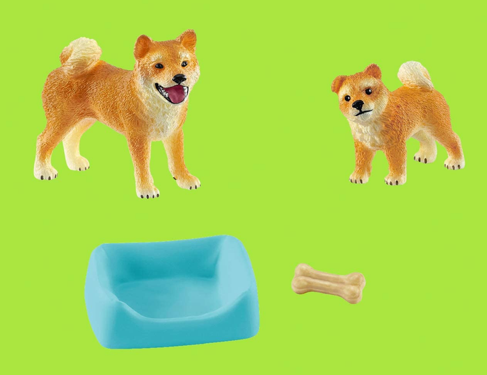 A set of dog toys, complete with a cozy bed and a chew bone, ready for your furry friend to enjoy.