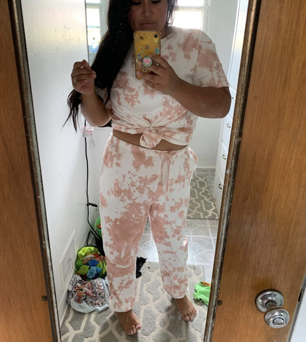 A customer posted a mirror selfie while wearing the orange loungewear set.