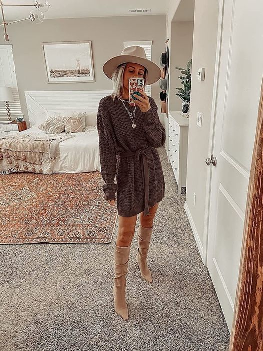 A model snapping a mirror selfie while rocking the brown dress.