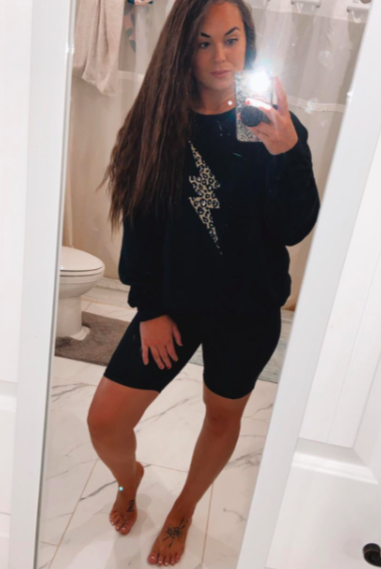 A customer review photo featuring them in the shorts paired with a cozy knit sweater.